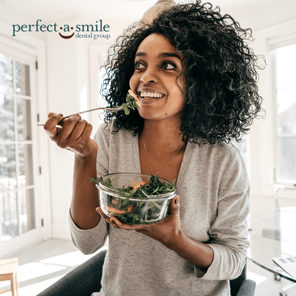 Woman smiling eating healthy food